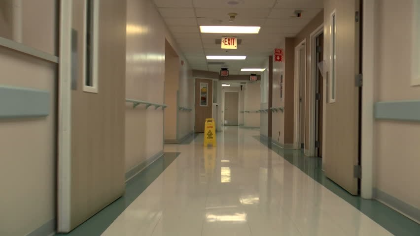 Hospital corridor with a cleaning sign